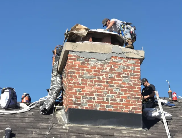 Raynham Chimney Sweep installing a custom chimney crown in Raynham, MA