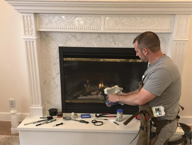 Raynham Chimney Sweep performing fireplace maintenance in Raynham, MA