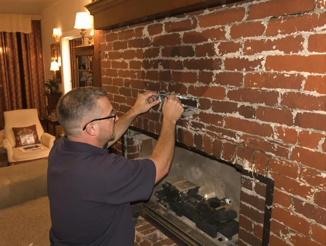 Raynham Chimney Sweep expert fixing a fireplace in Raynham, MA